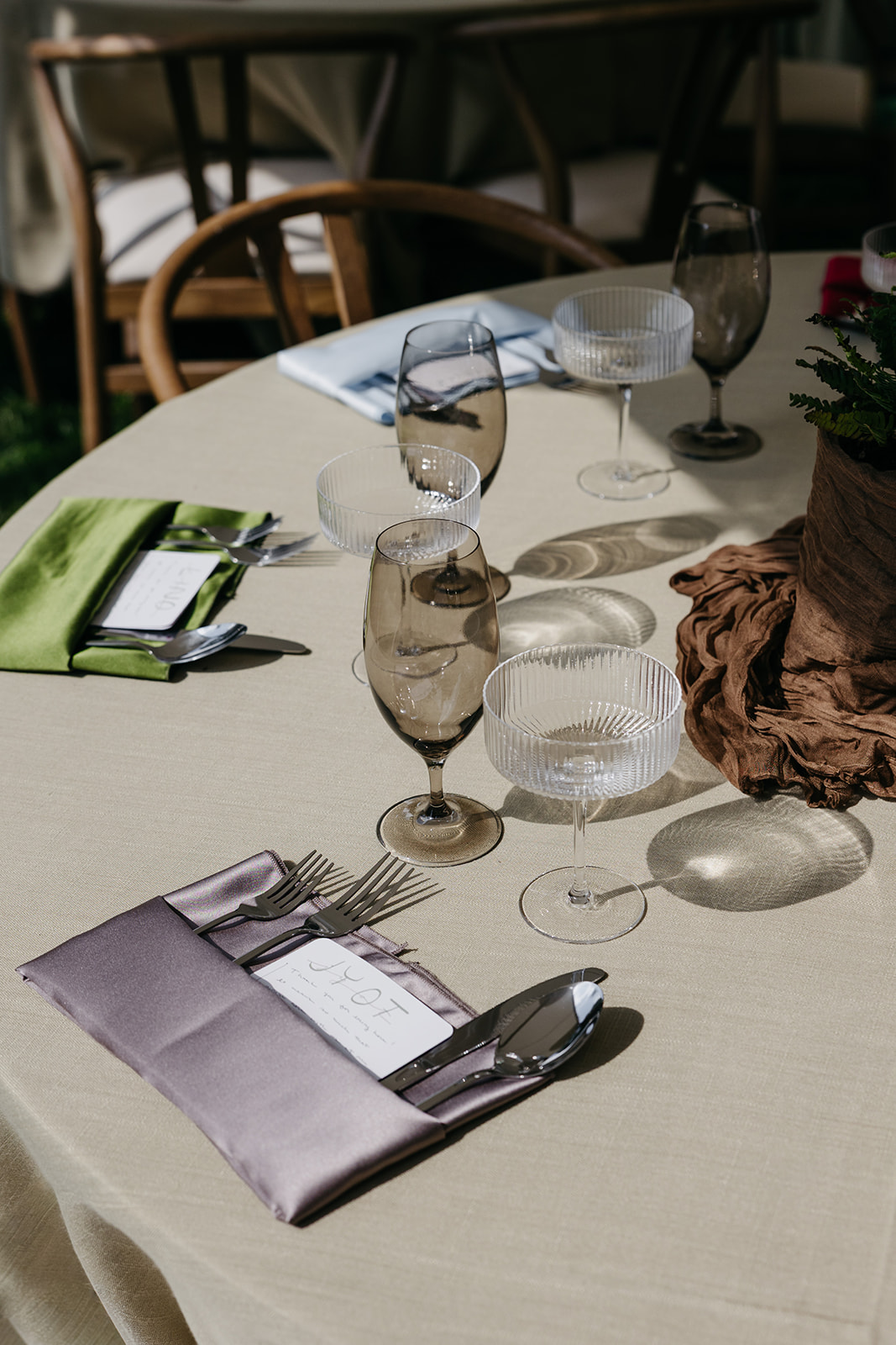 Editorial wedding table setting with neutral linens and glassware 