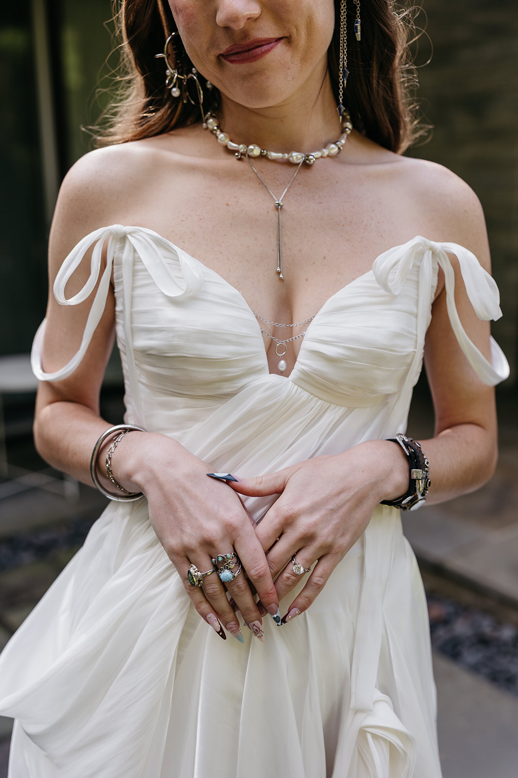 Close-up of the bride’s Rue de Seine wedding dress and layered jewelry at The Mod House in Ellenville, NY.