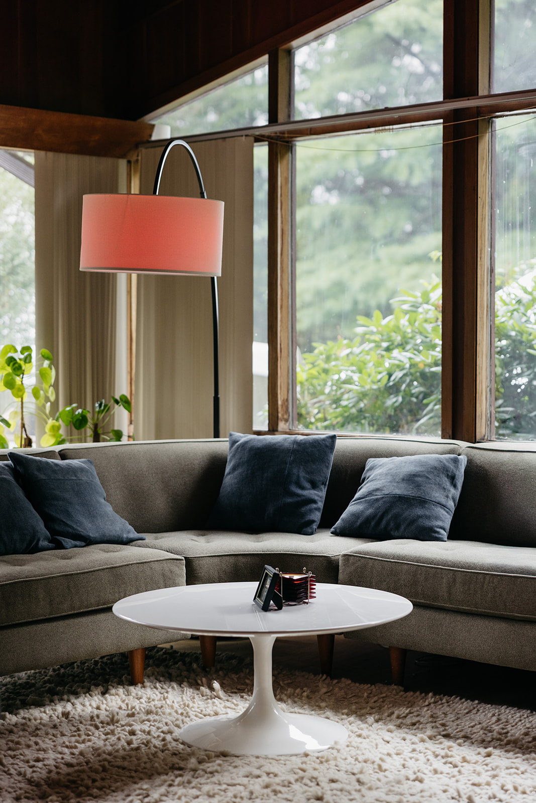 Mid-century modern living room at The Mod House with warm wood tones, vintage furniture, and house party wedding vibes.