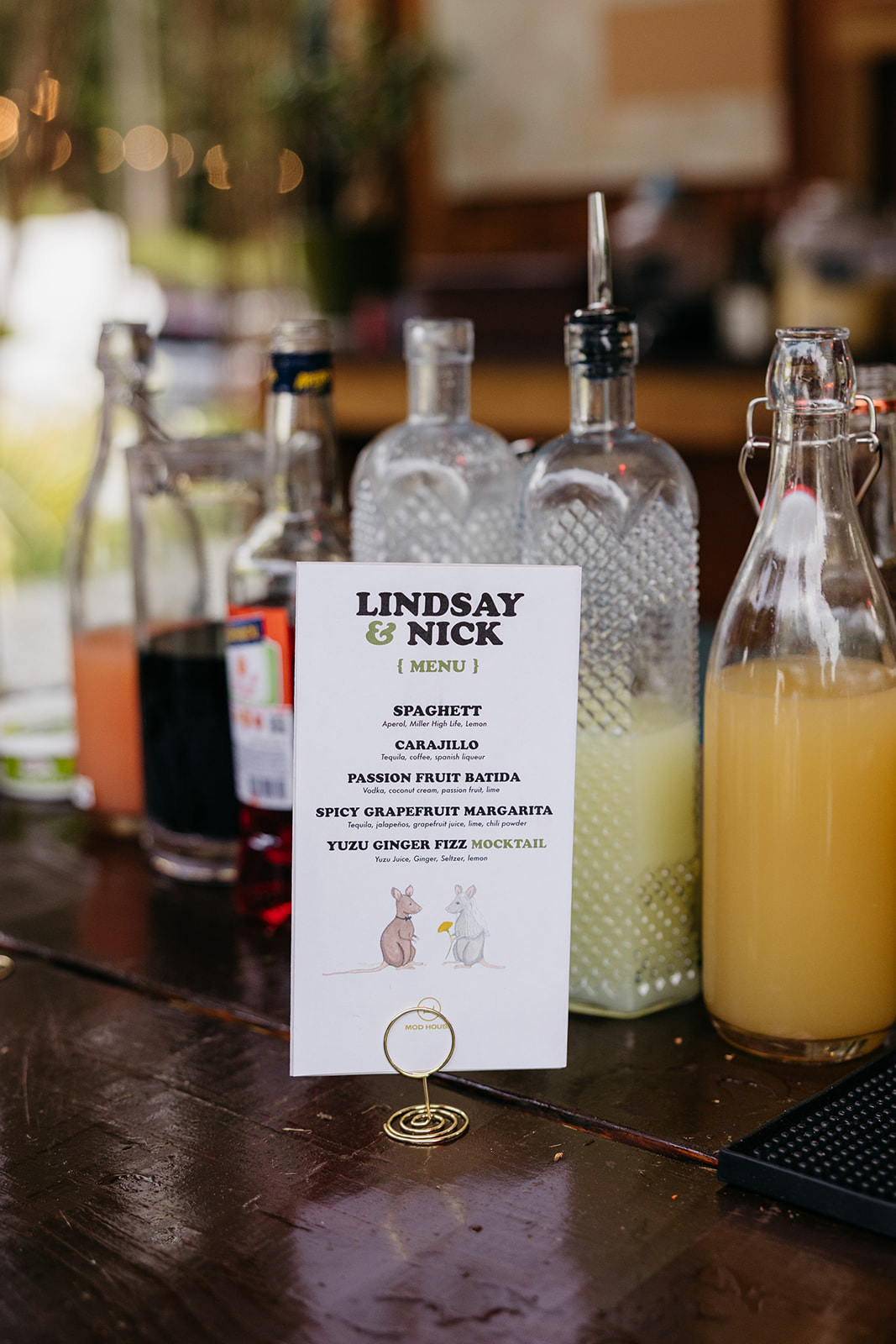 Custom cocktail menu for Lindsay and Nick displayed at the bar during their wedding at The Mod House in Ellenville, NY.