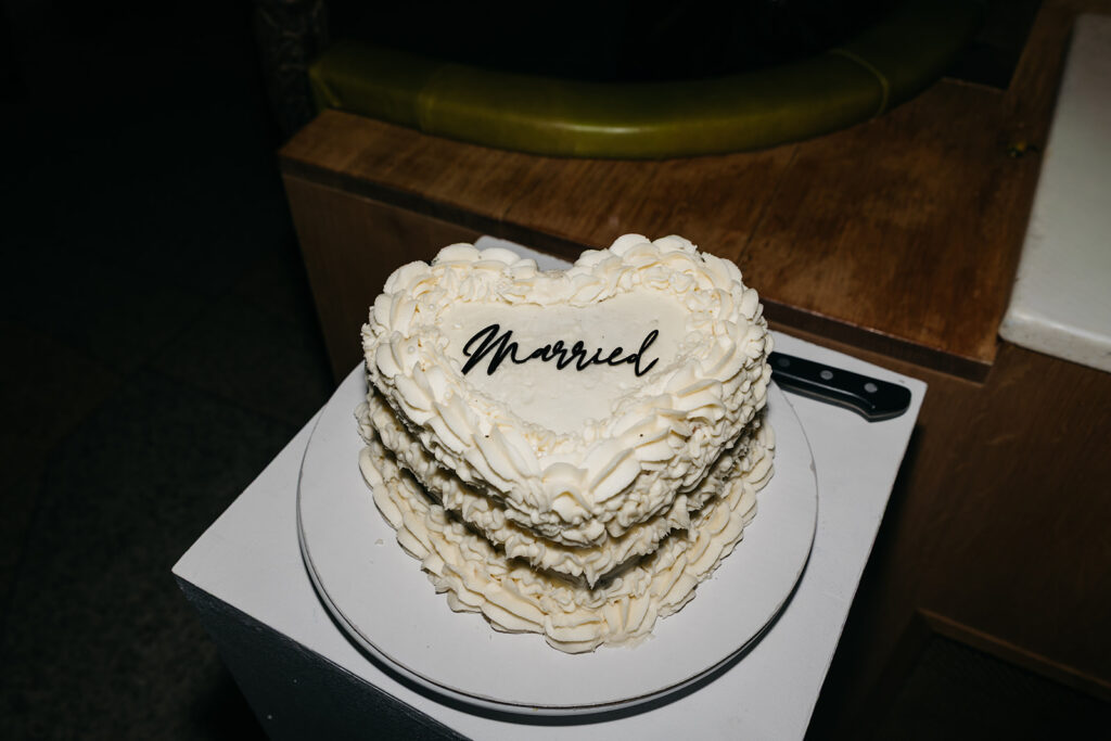 Heart shaped wedding cake with “Married” written on top