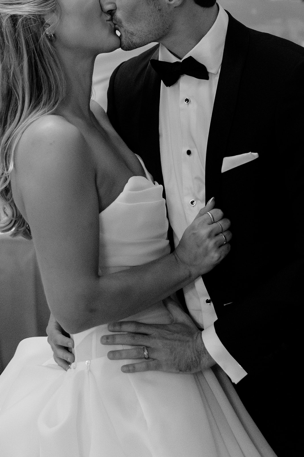 Black and white close-up wedding portrait of the bride and groom sharing a quiet kiss during their Acadia NYC wedding.
