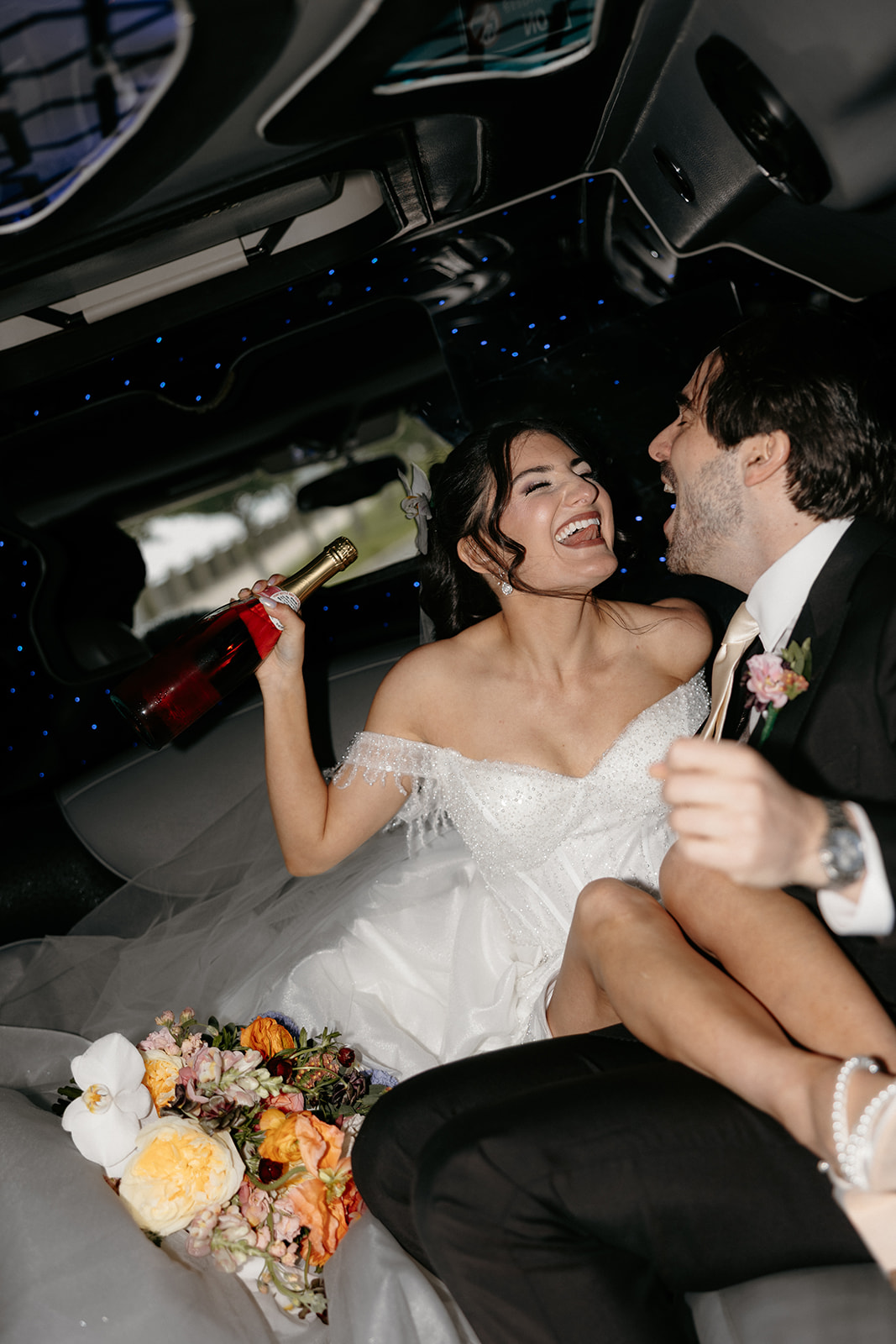 bride and groom in a limo wedding photo