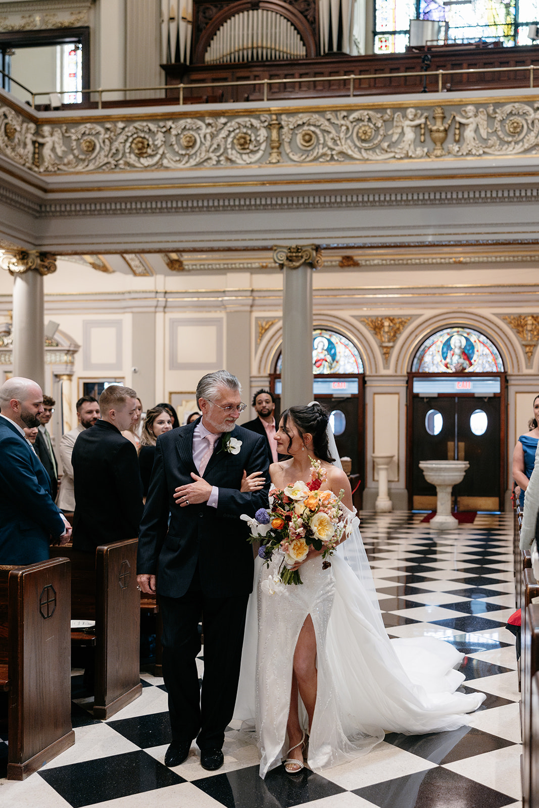 father and bride walking down the aisle at St. Francis de Sales Roman Catholic Church
