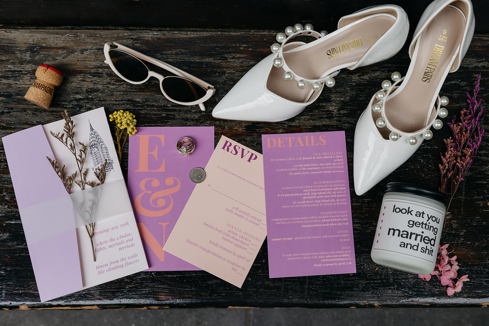 flatlay photo of colorful wedding invitation and accessories