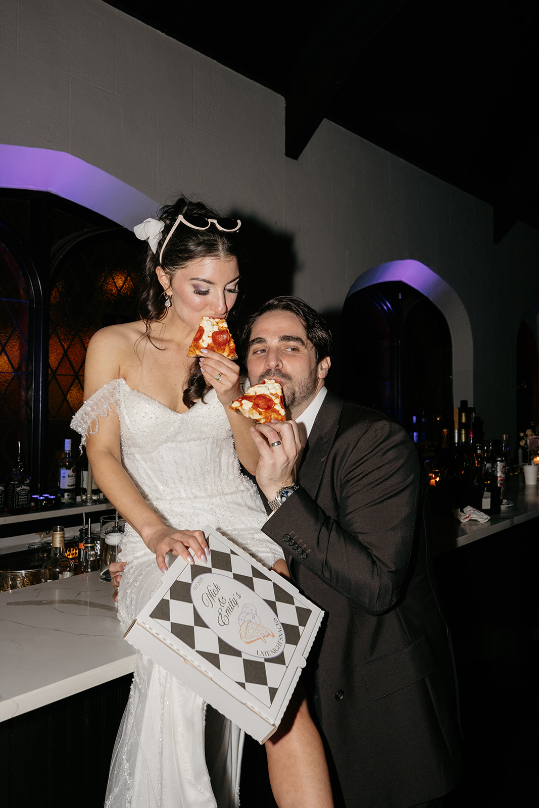 bride and groom eating pizza at their NYC wedding