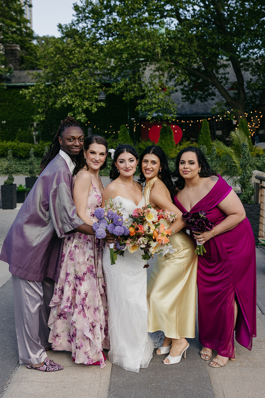 Colorful bridesmaids with the bride in the park at Roosevelt Island New York City