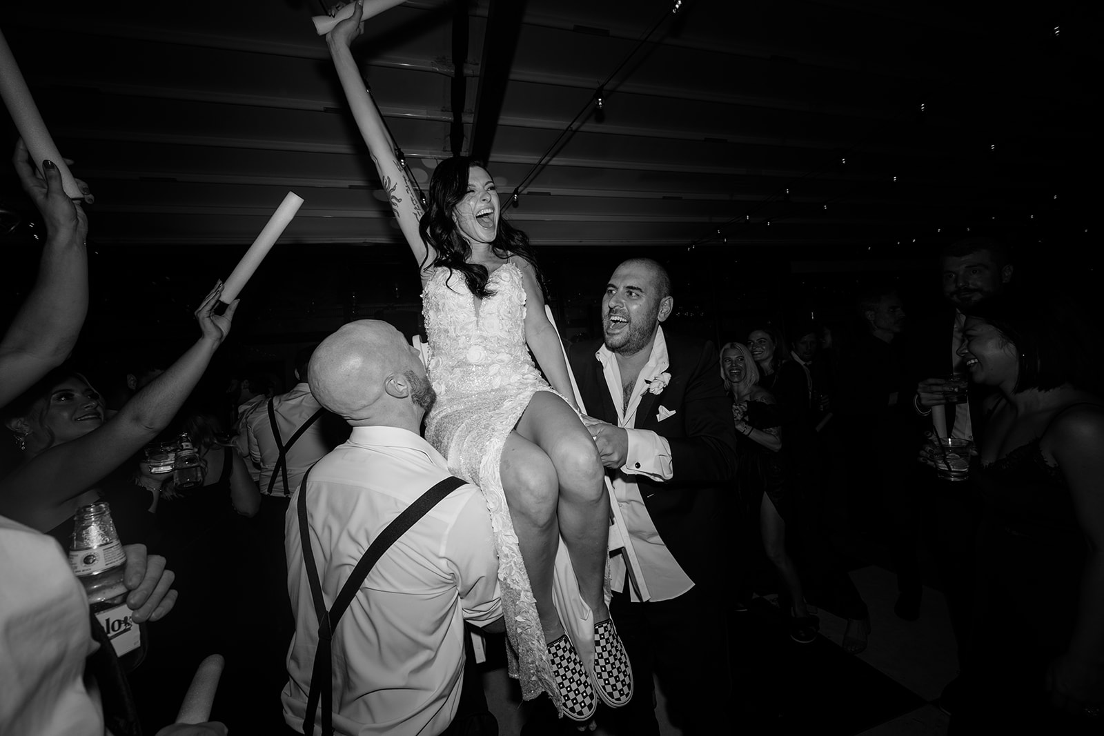 Bride lifted into the air on the dance floor while cheering guests celebrate during a lively Chicago wedding reception