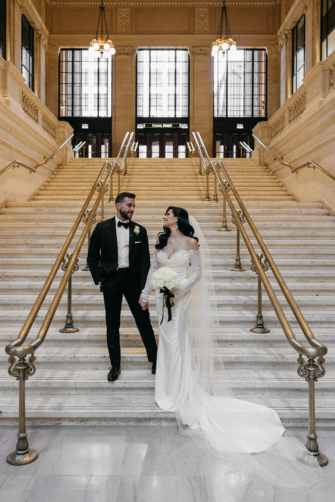Bride and groom walking down the grand staircase at Union Station during their Chicago Union Station wedding portraits