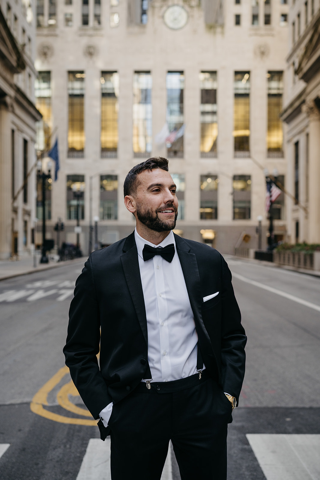 Groom portrait in downtown Chicago with historic architecture during Chicago Union Station wedding portraits