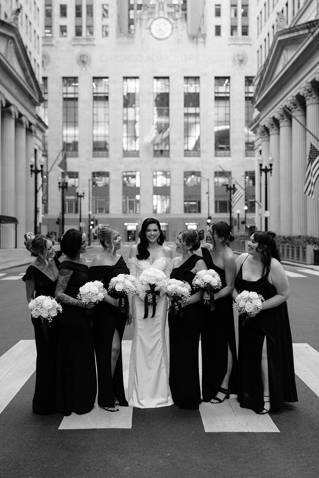 Bride and bridesmaids posing together in downtown Chicago during Chicago Union Station wedding portraits
