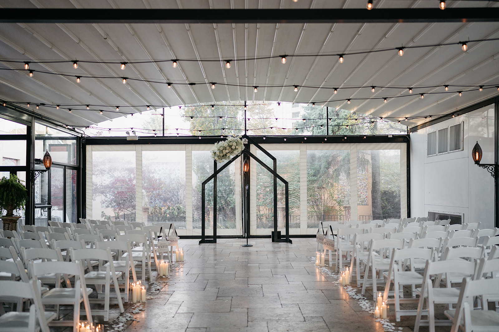 Elegant ceremony setup with white chairs, candles, and string lights ready for a Chicago wedding