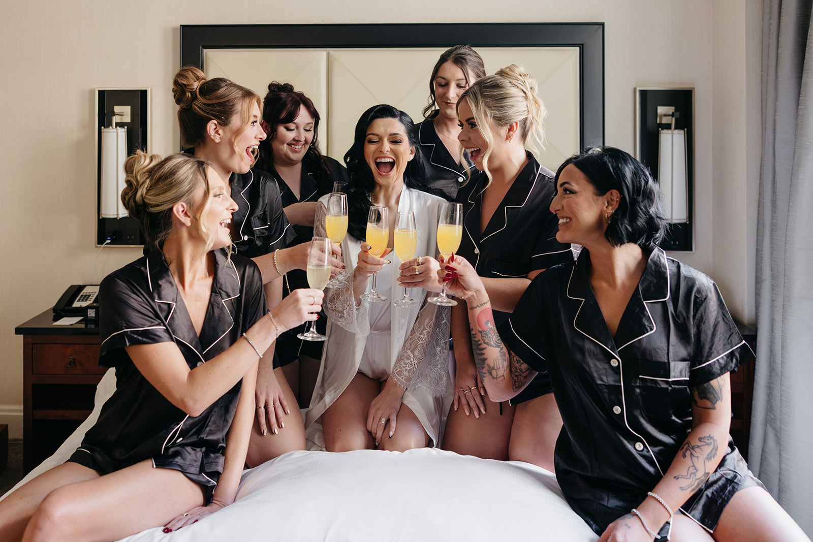 Bridal party toasting champagne together during the getting ready moments in a Chicago hotel suite