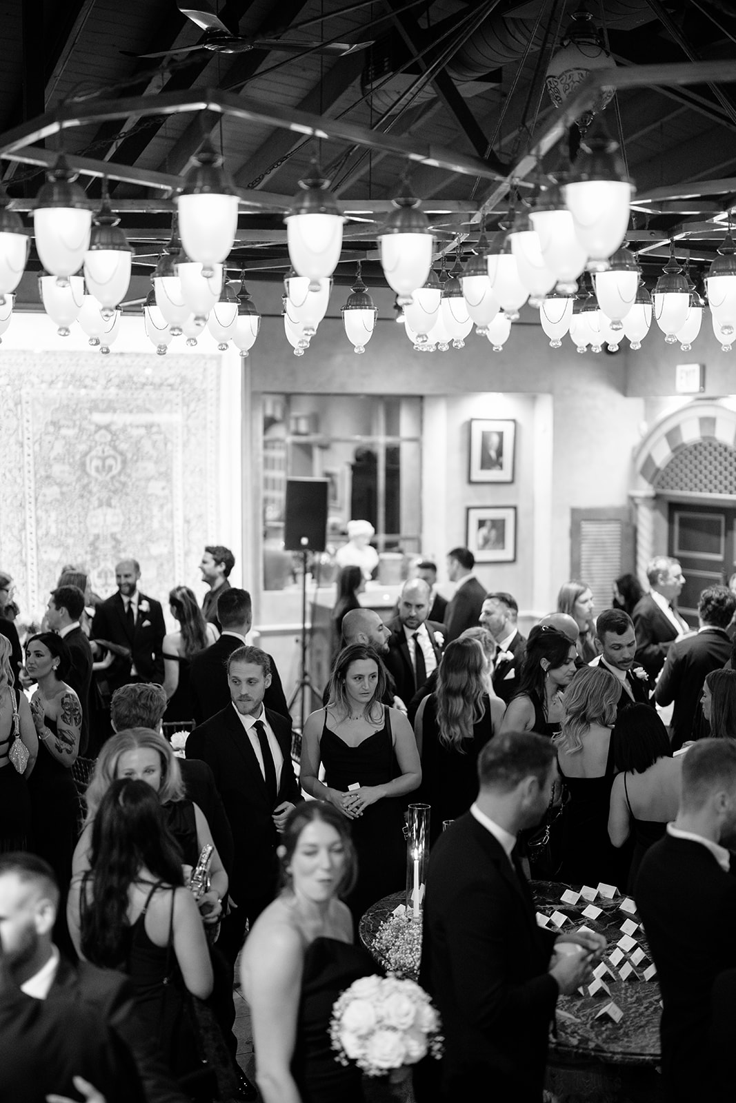 Guests mingling during cocktail hour under vintage chandeliers at a Chicago wedding reception