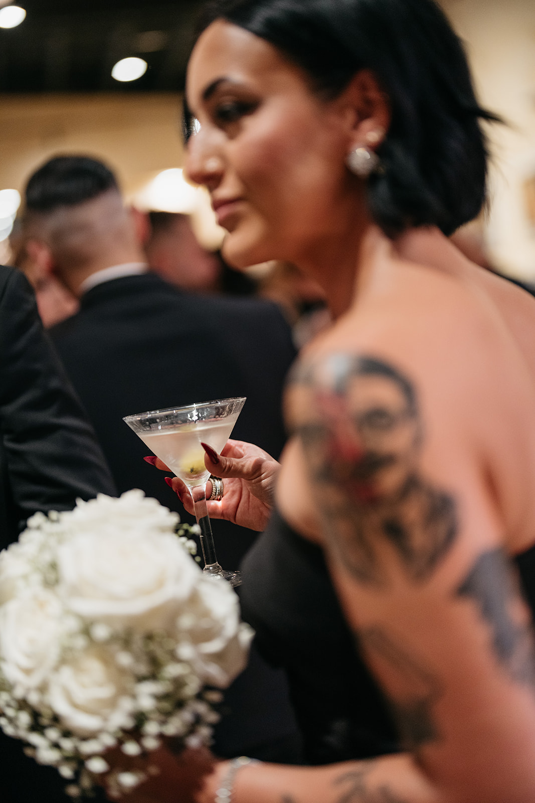 Wedding guest holding a martini and bouquet during cocktail hour at an elegant Chicago wedding reception
