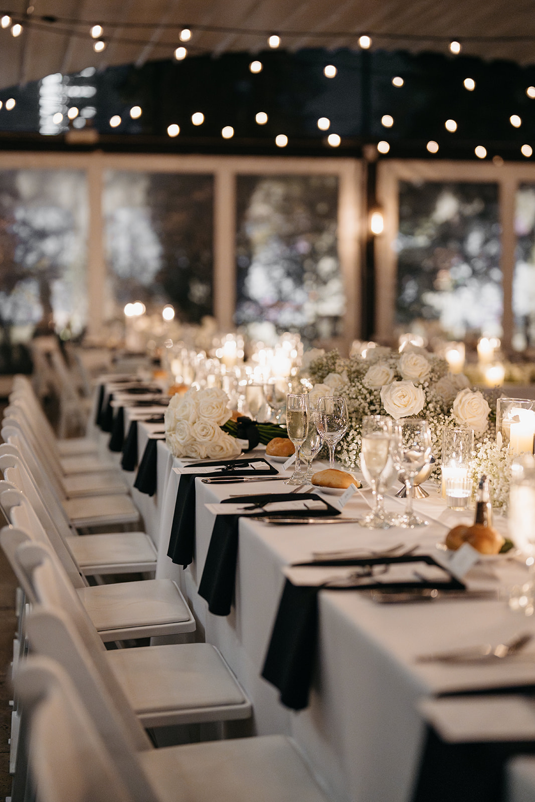 Elegant reception tables with white roses and candlelight décor at a Galleria Marchetti wedding in Chicago