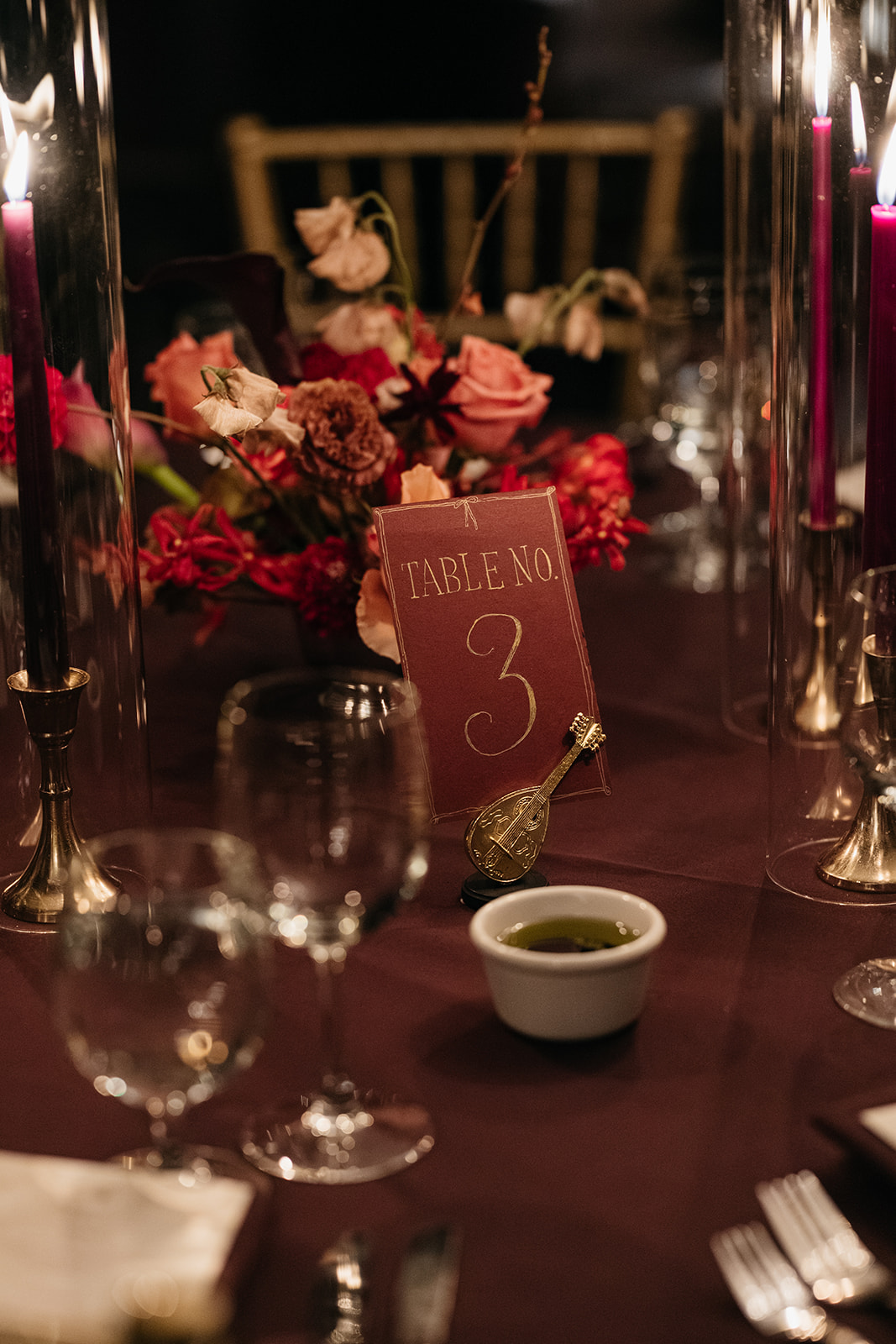 Romantic table setting with table number and red florals at Montauk Club wedding reception