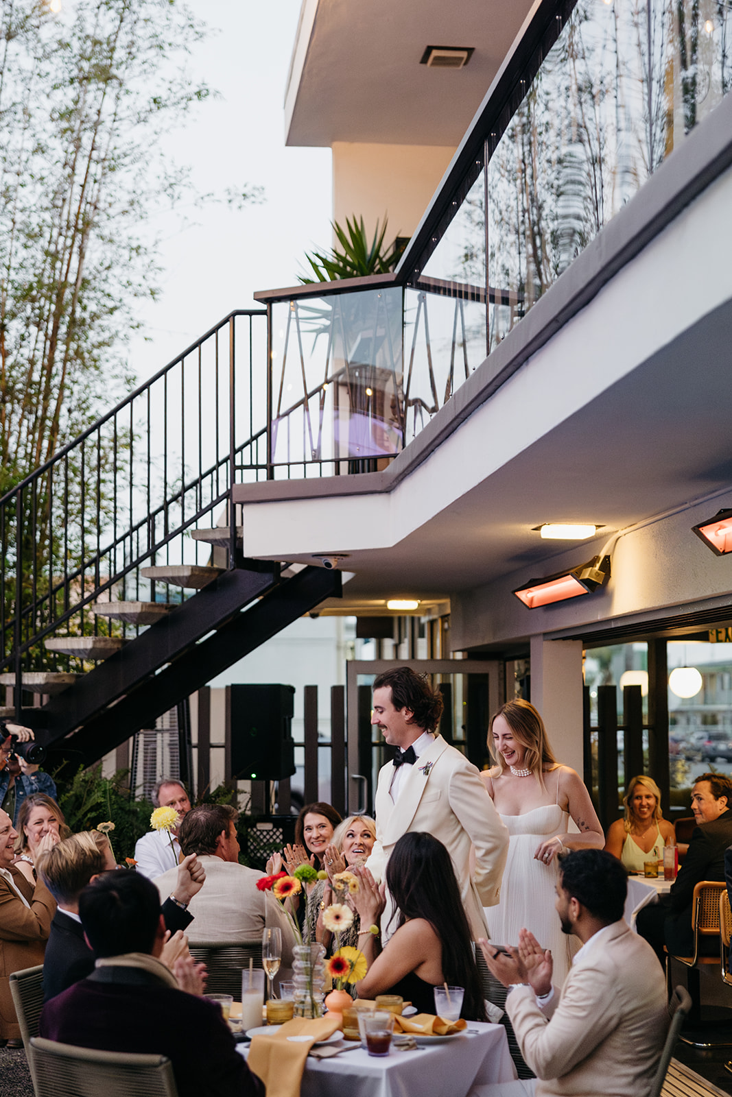 Ceremony entrance with guests applauding couple at outdoor San Diego wedding venue