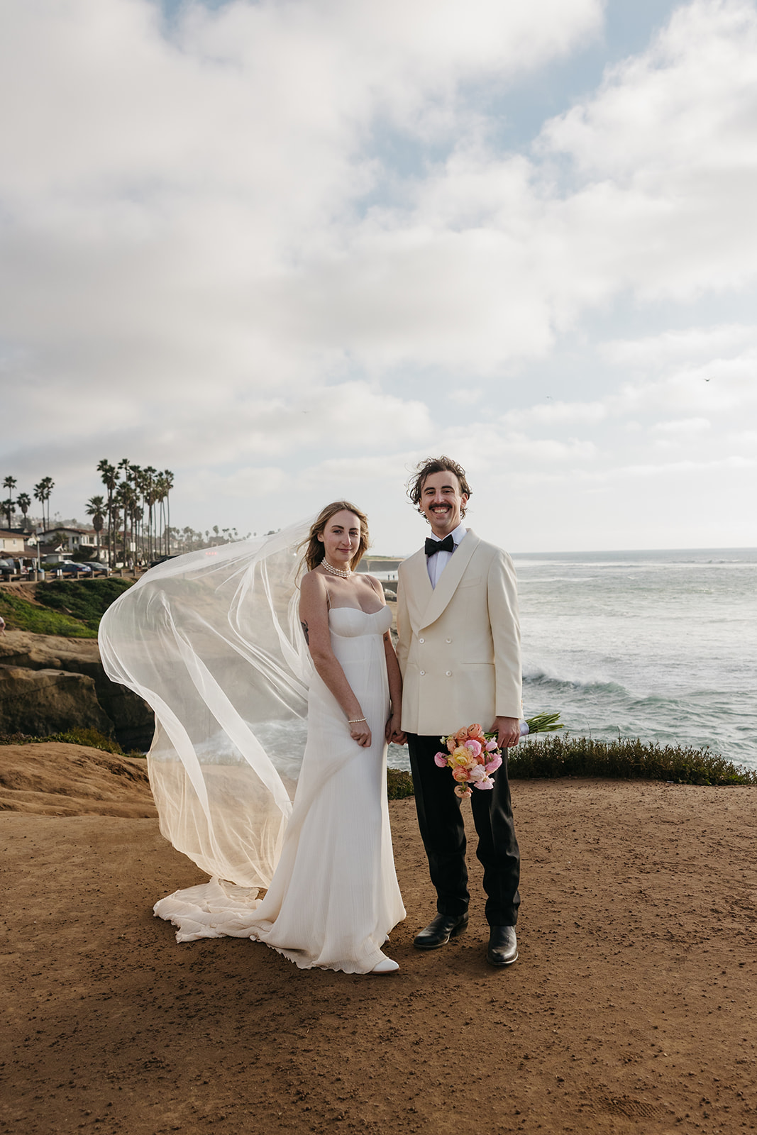 Bride and groom portraits at sunset cliffs with ocean view, romantic San Diego wedding photography