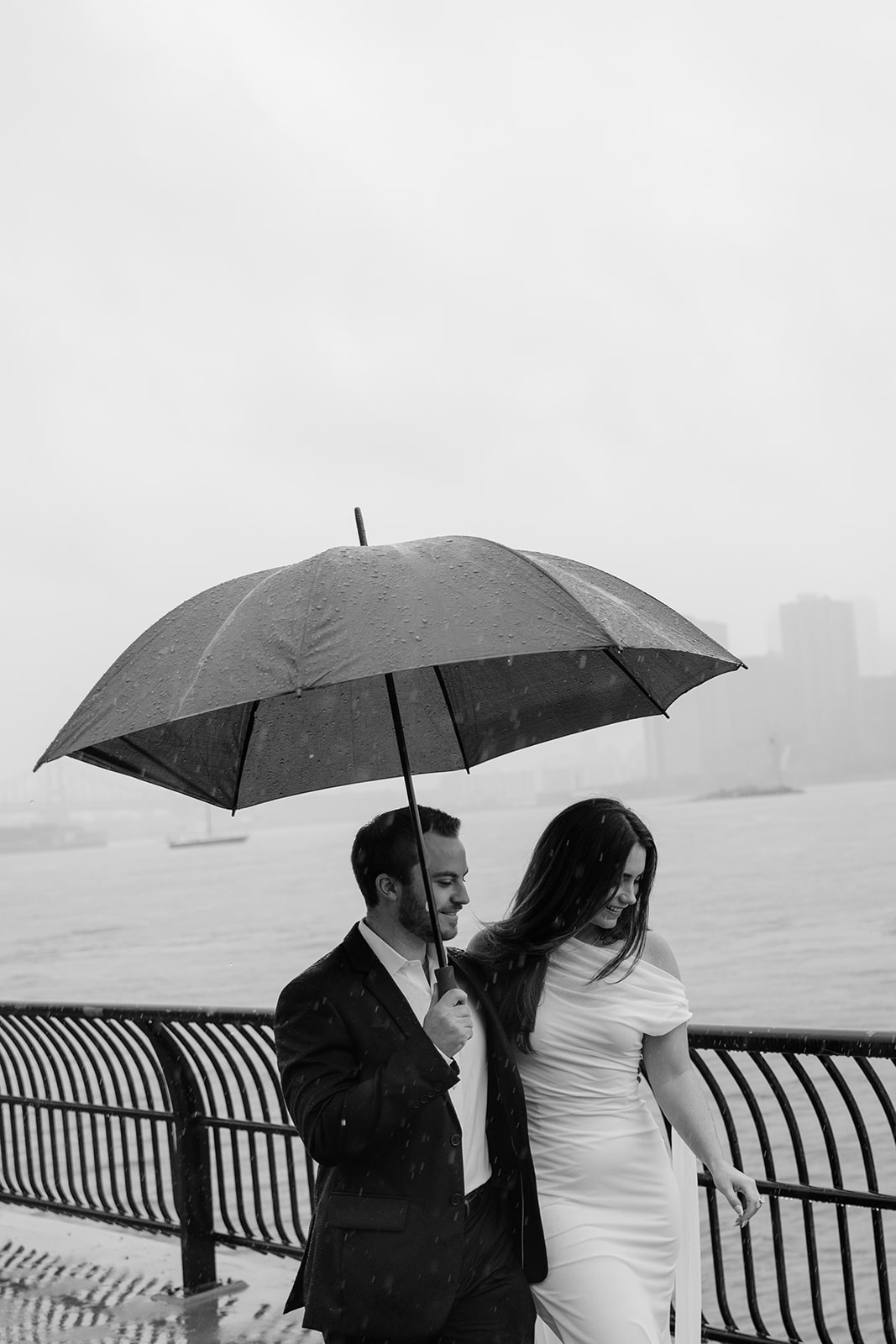Moody NYC engagement photos in the rain for unconventional couples