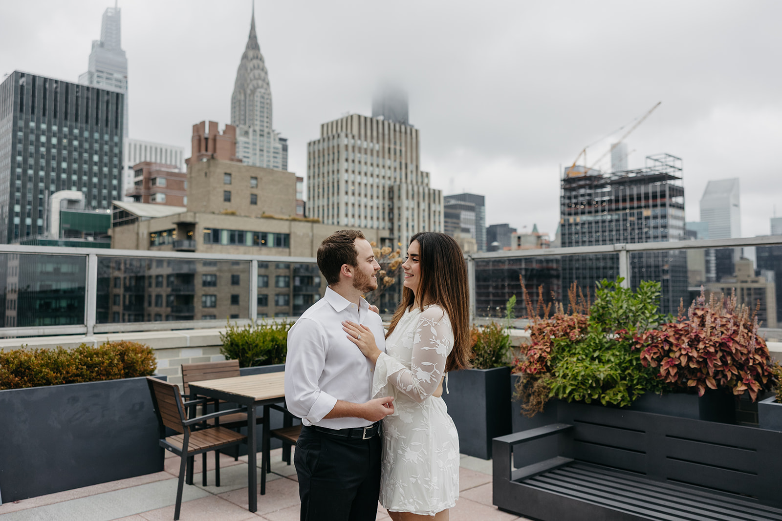 Romantic NYC engagement session featuring rain and city skyline
