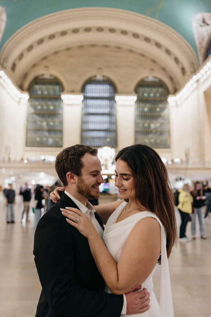 Close up of an NYC couple embracing each other at the grand central station