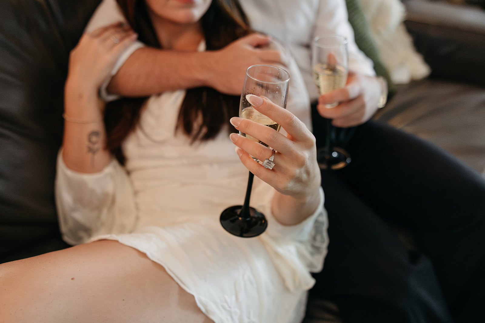 intimate shot of couple sitting on their apartment couch for relaxed NYC engagement photography